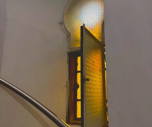 Sunlit stairwell window in Constanța