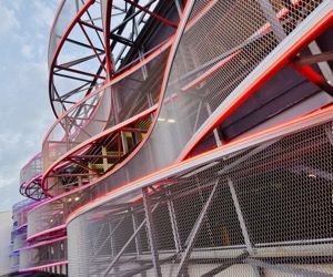 Illuminated industrial mesh forming rhythmic curves