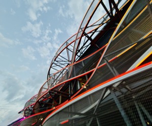 Geometric steel waves edged with saturated neon light